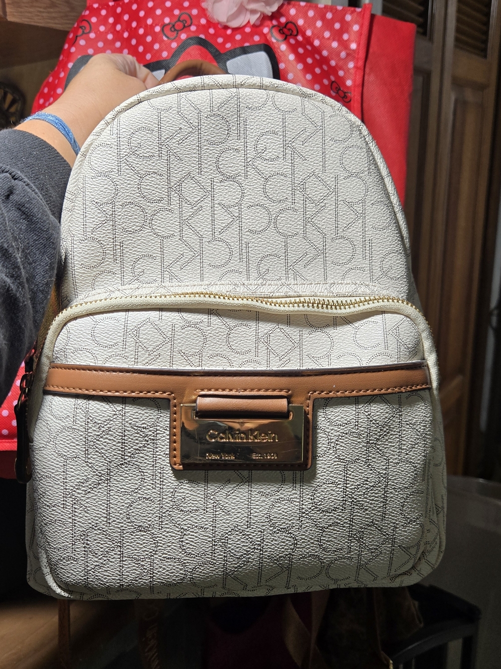 Calvin Klein Cream Mini Backpack with Tan Trim and Gold Plaque